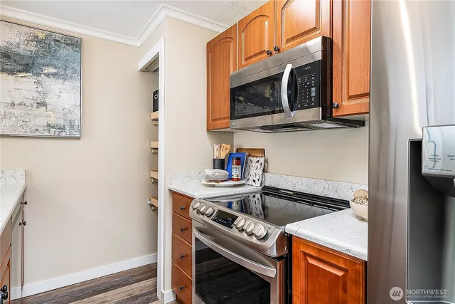a kitchen with stainless steel appliances granite countertop a stove and a microwave