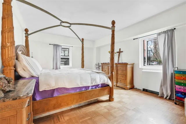 a bed sitting in a room next to a window