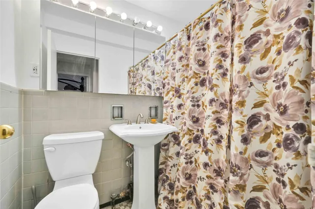 a bathroom with a toilet and a sink