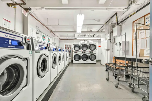 a utility room with multiple dryer and washer
