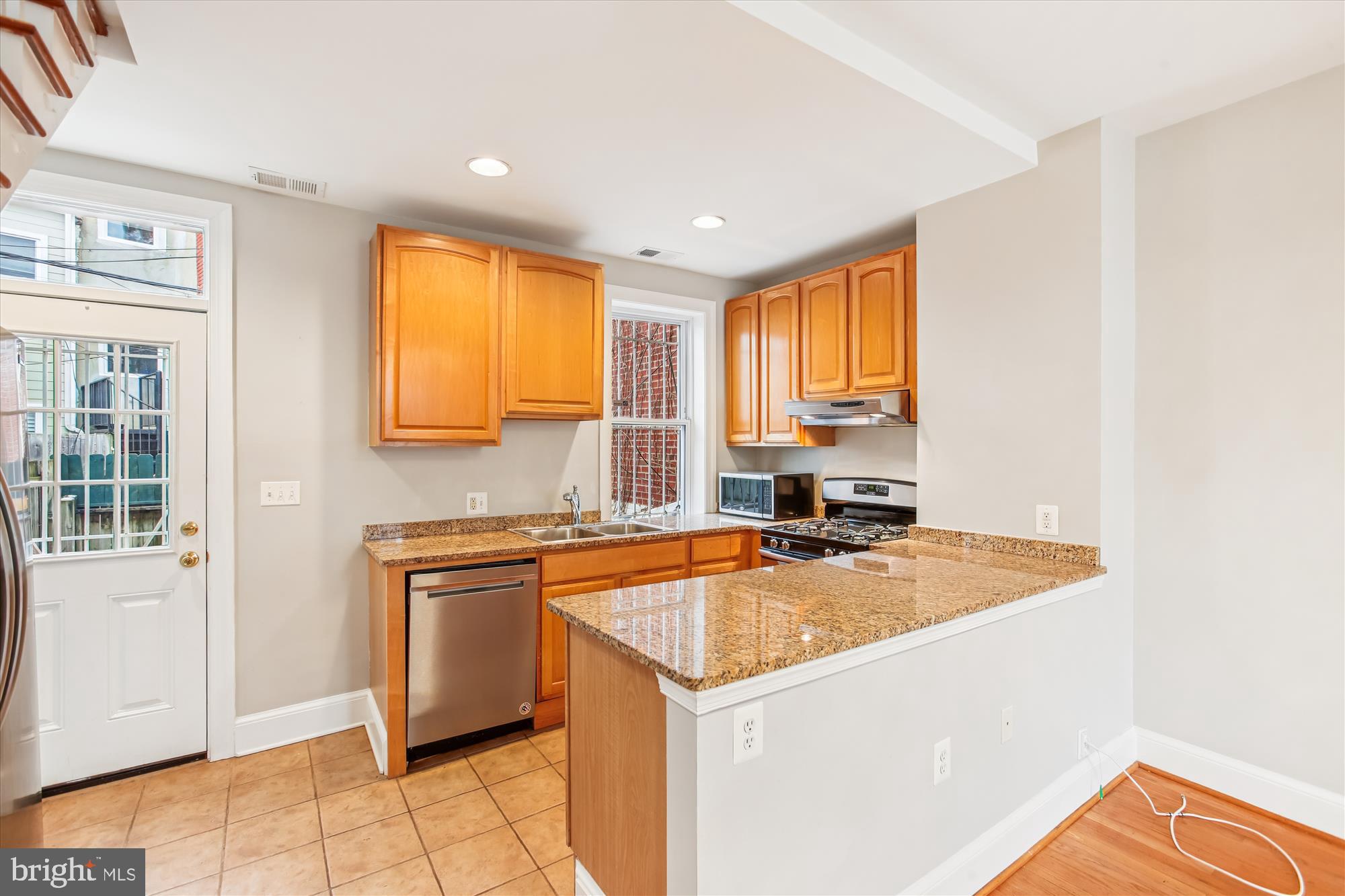 1610 4th Street Northwest Washington, DC 20001 - Photo 13 of 47 a kitchen with a sink a stove and cabinets