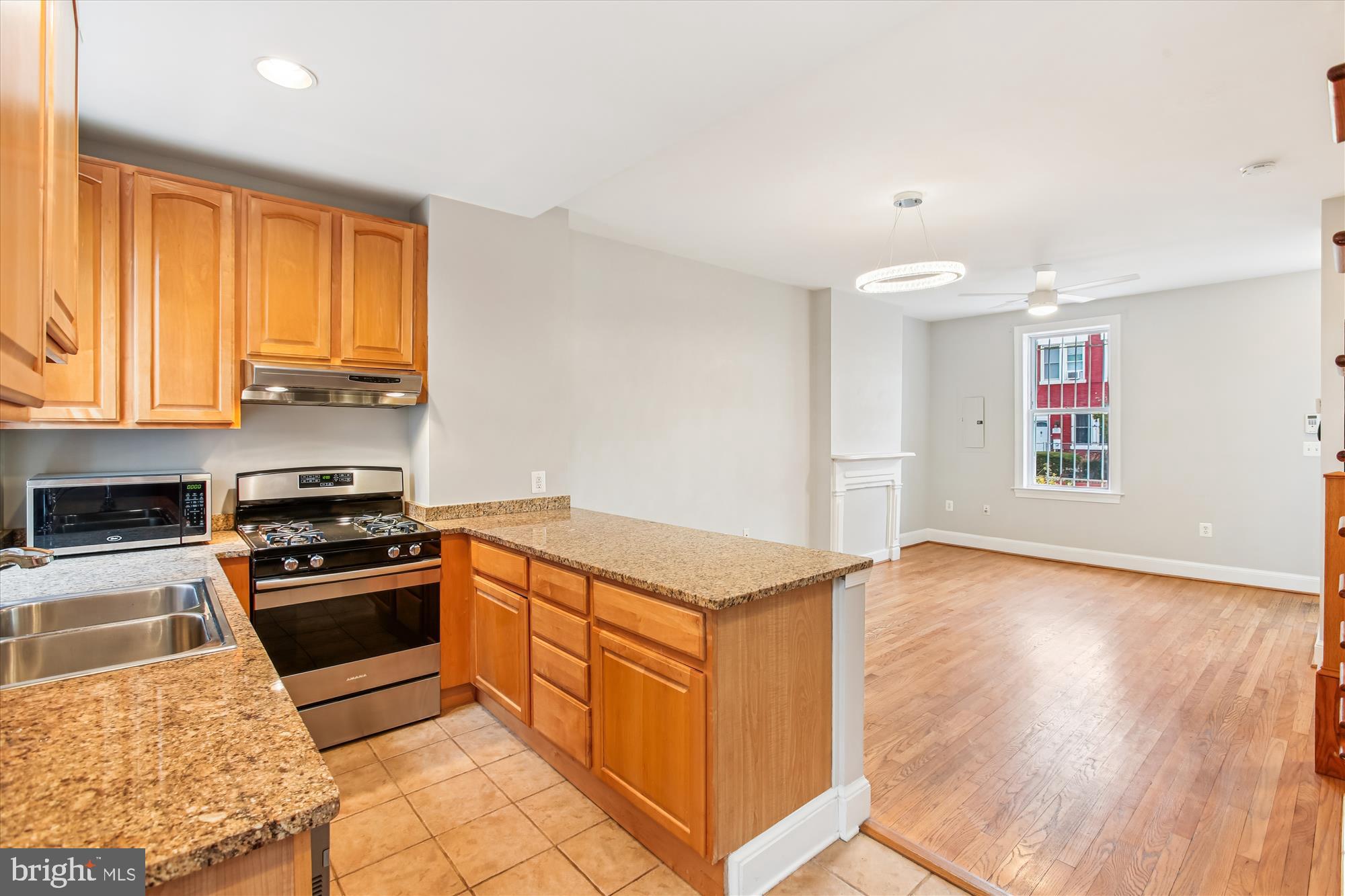 1610 4th Street Northwest Washington, DC 20001 - Photo 15 of 47 a kitchen with granite countertop a stove and a sink