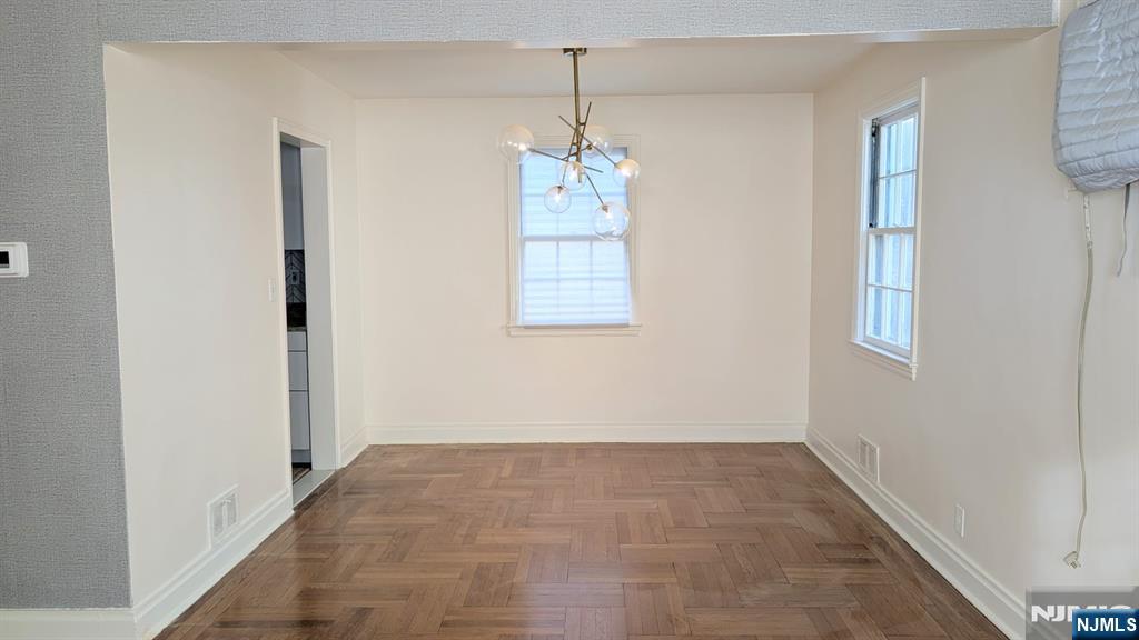 441 New Bridge Road Bergenfield, NJ 07621 - Photo 3 of 11 a view of an empty room with window and stairs