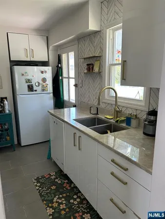 a kitchen with sink refrigerator and window