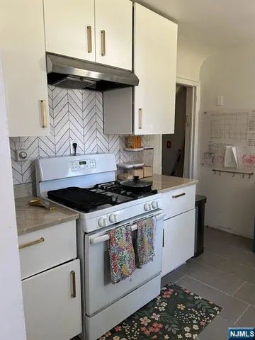a kitchen with stainless steel appliances granite countertop a stove and a refrigerator