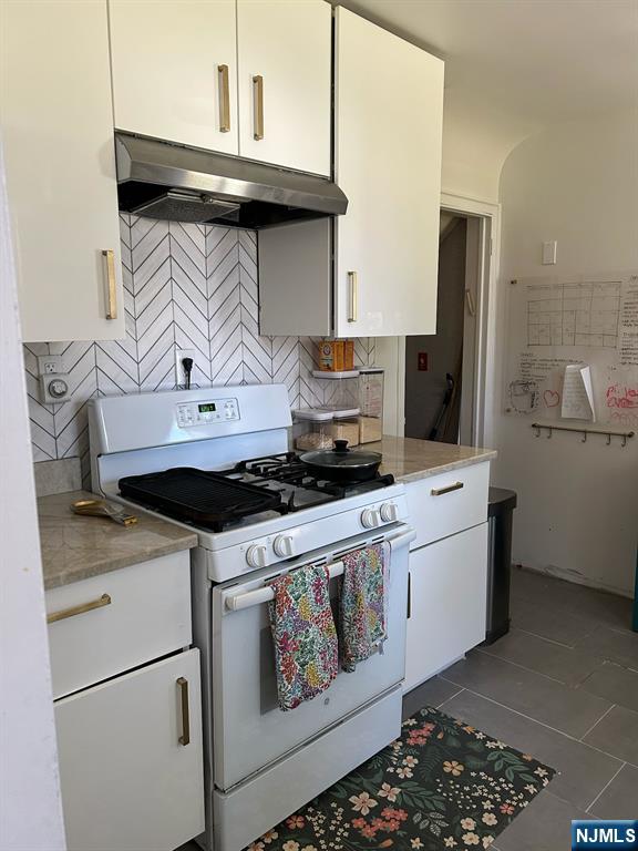 441 New Bridge Road Bergenfield, NJ 07621 - Photo 6 of 11 a kitchen with stainless steel appliances granite countertop a stove and a refrigerator