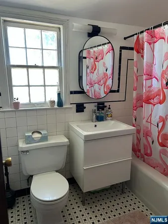 a bathroom with a sink a mirror and a toilet
