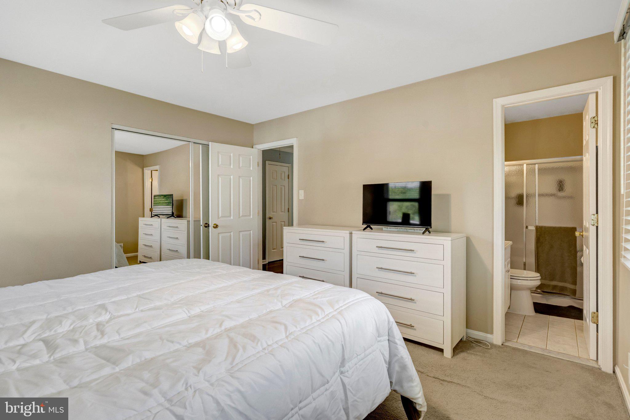 7212 Galgate Drive Springfield, VA 22153 - Photo 14 of 39 a bedroom with a bed and a flat screen tv