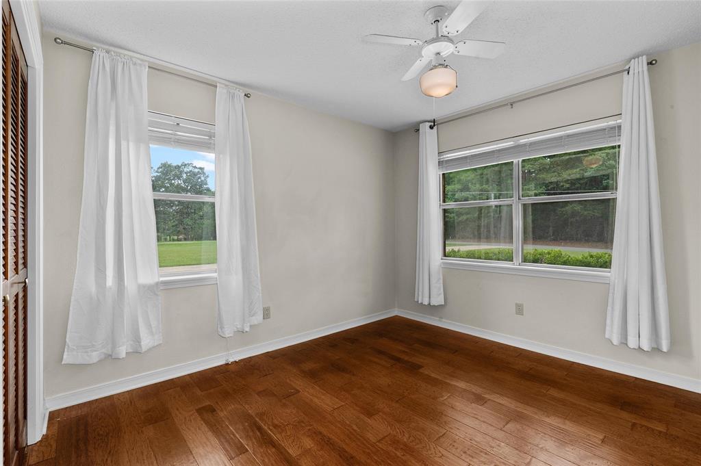 927 Stonewall-Preston Road Stonewall, LA 71078 - Photo 20 of 28 a view of empty room with wooden floor and fan