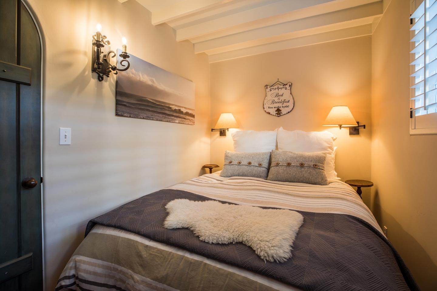 0 Seventh Ave 2 Carmel, CA 93923 - Photo 19 of 23 a bedroom with a bed and a chandelier