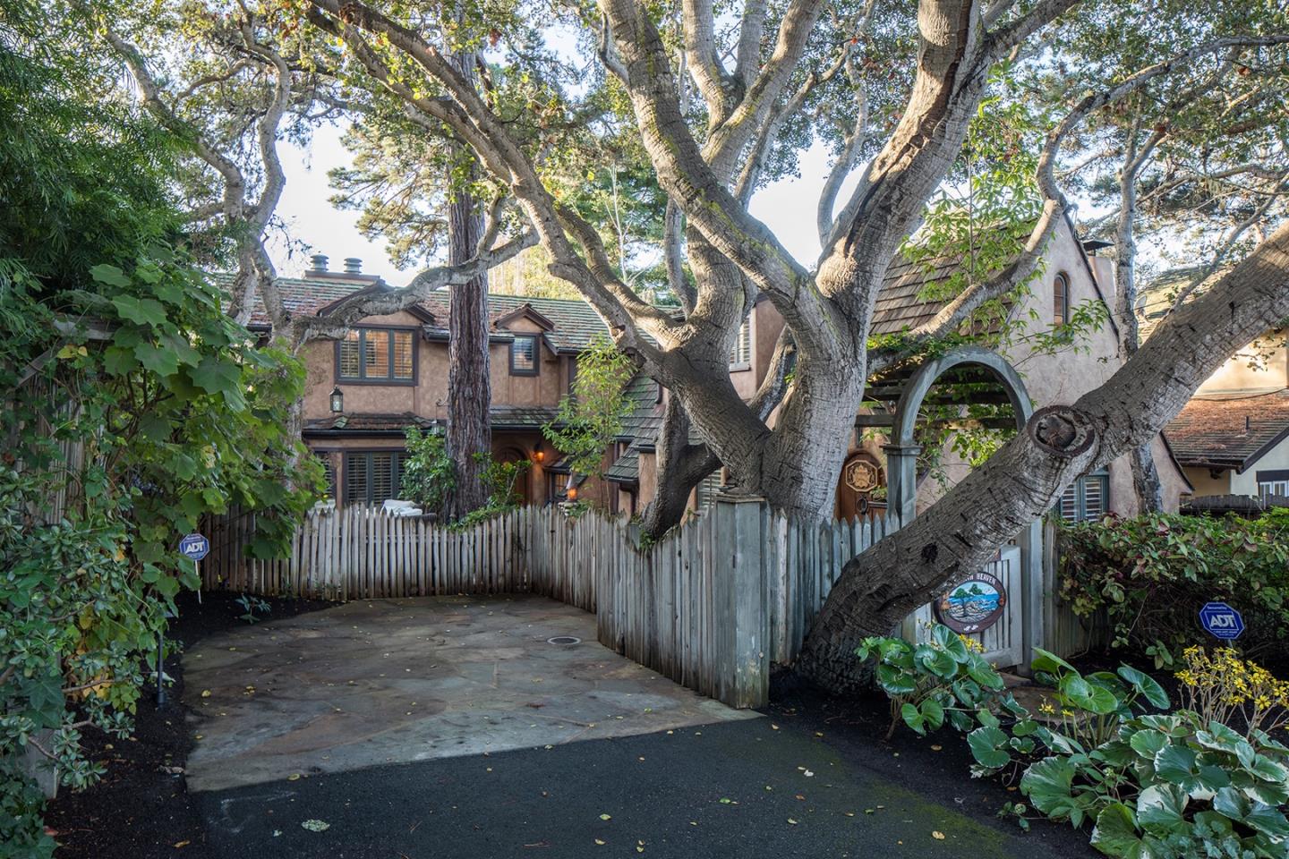 0 Seventh Ave 2 Carmel, CA 93923 - Photo 3 of 23 a view of a brick house with a large trees and wooden fence