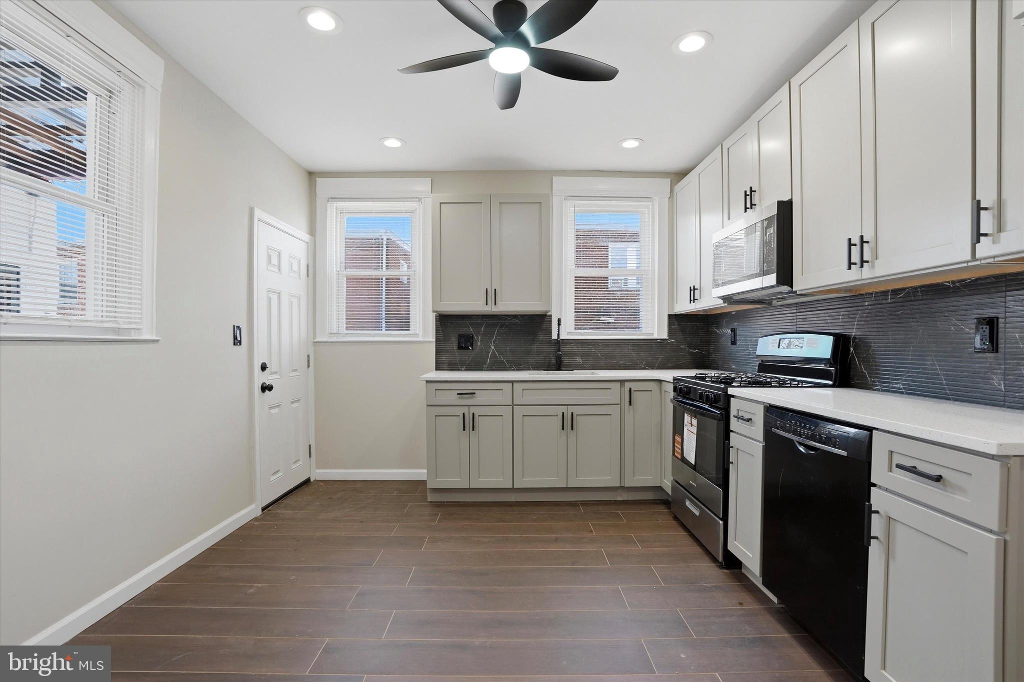 6258 Magnolia Street Philadelphia, PA 19144 - Photo 11 of 25 a kitchen with cabinets appliances and a window