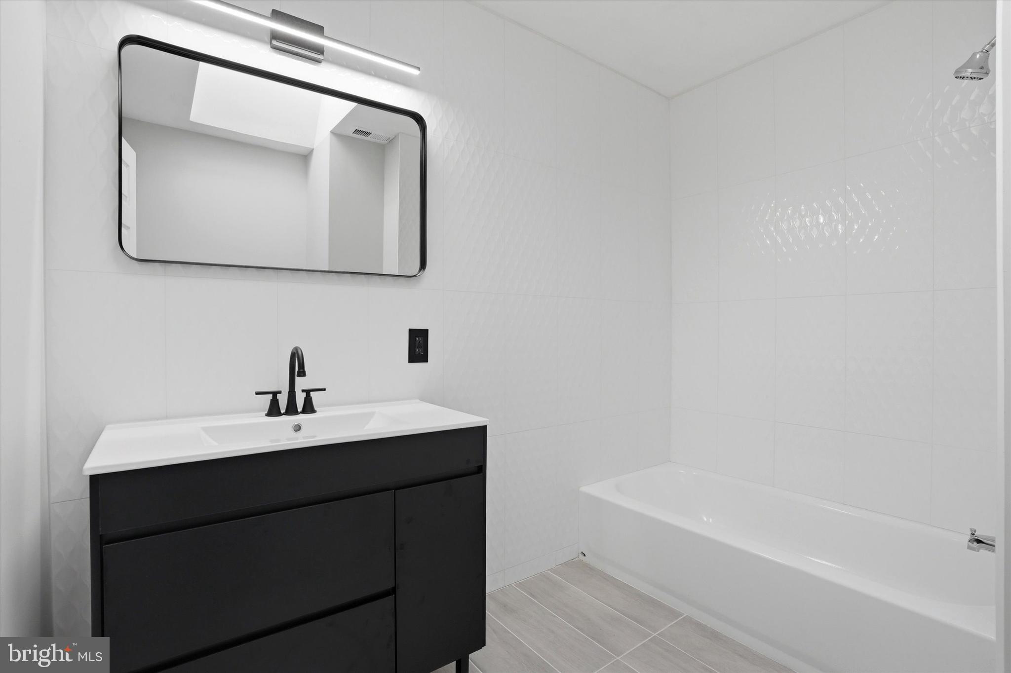 6258 Magnolia Street Philadelphia, PA 19144 - Photo 17 of 25 a bathroom with a toilet sink and mirror