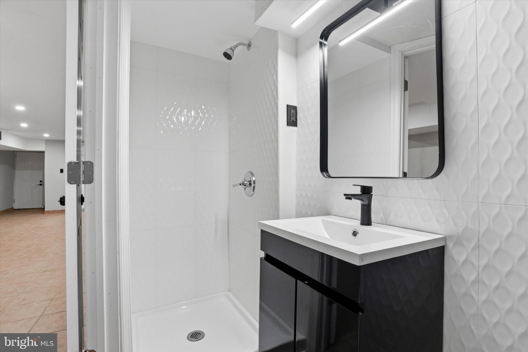 6258 Magnolia Street Philadelphia, PA 19144 - Photo 23 of 25 a bathroom with a sink mirror and shower