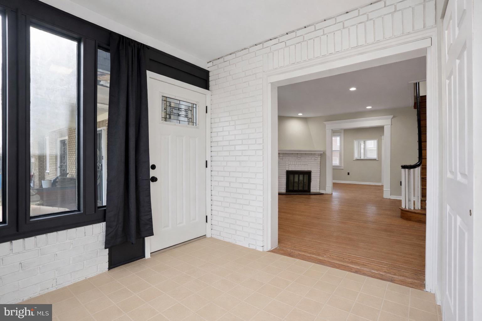 6258 Magnolia Street Philadelphia, PA 19144 - Photo 3 of 25 a view of a hallway with wooden floor and a kitchen