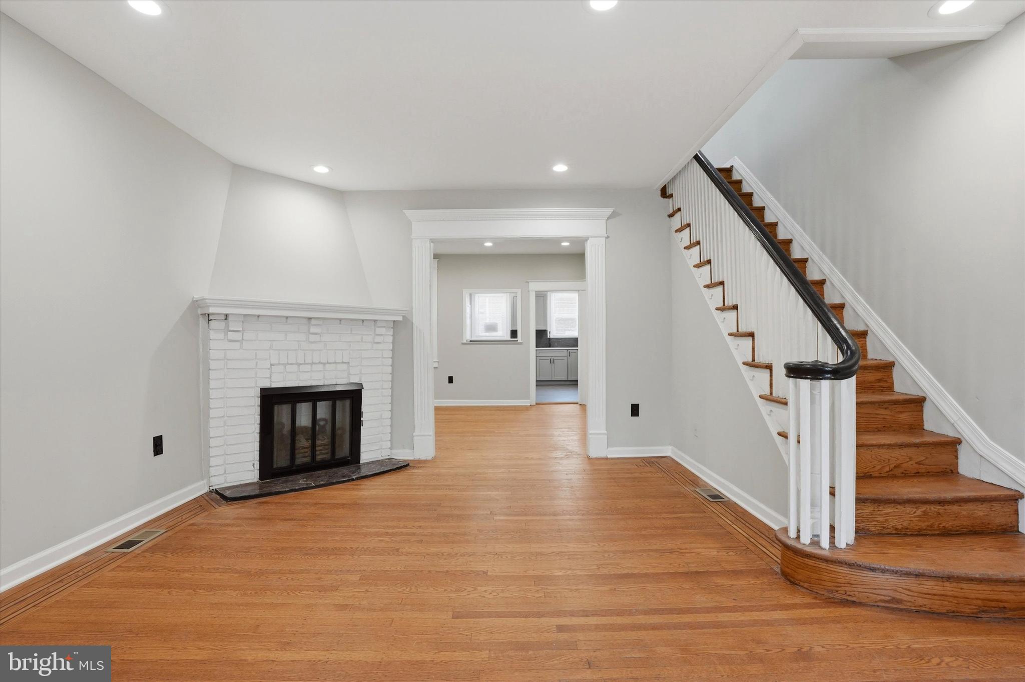 6258 Magnolia Street Philadelphia, PA 19144 - Photo 4 of 25 a view of an empty room with wooden floor fireplace and a window
