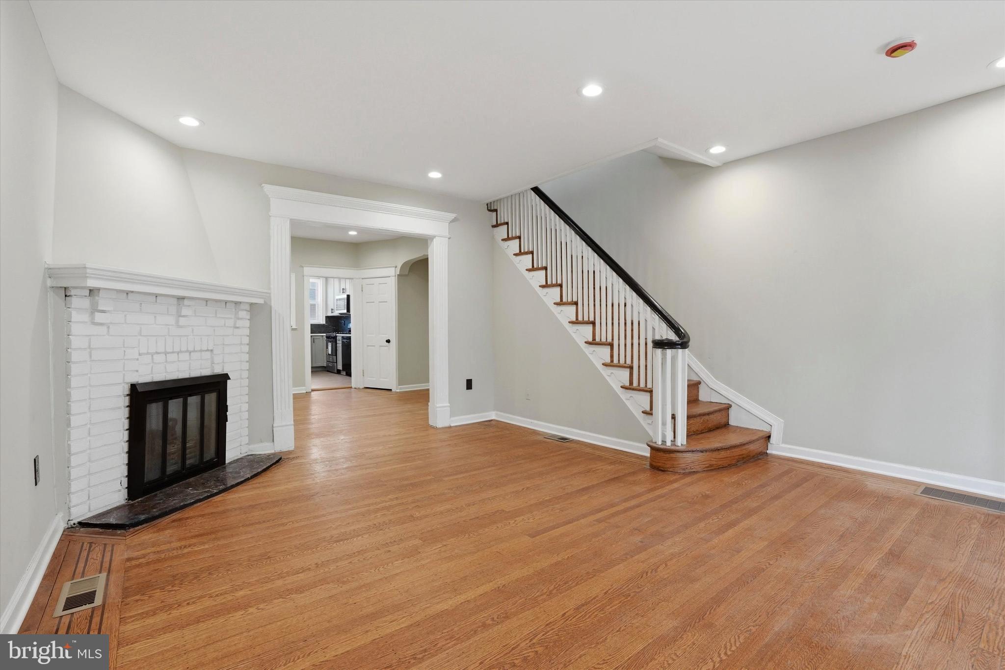 6258 Magnolia Street Philadelphia, PA 19144 - Photo 5 of 25 a view of a livingroom with wooden floor and a fireplace