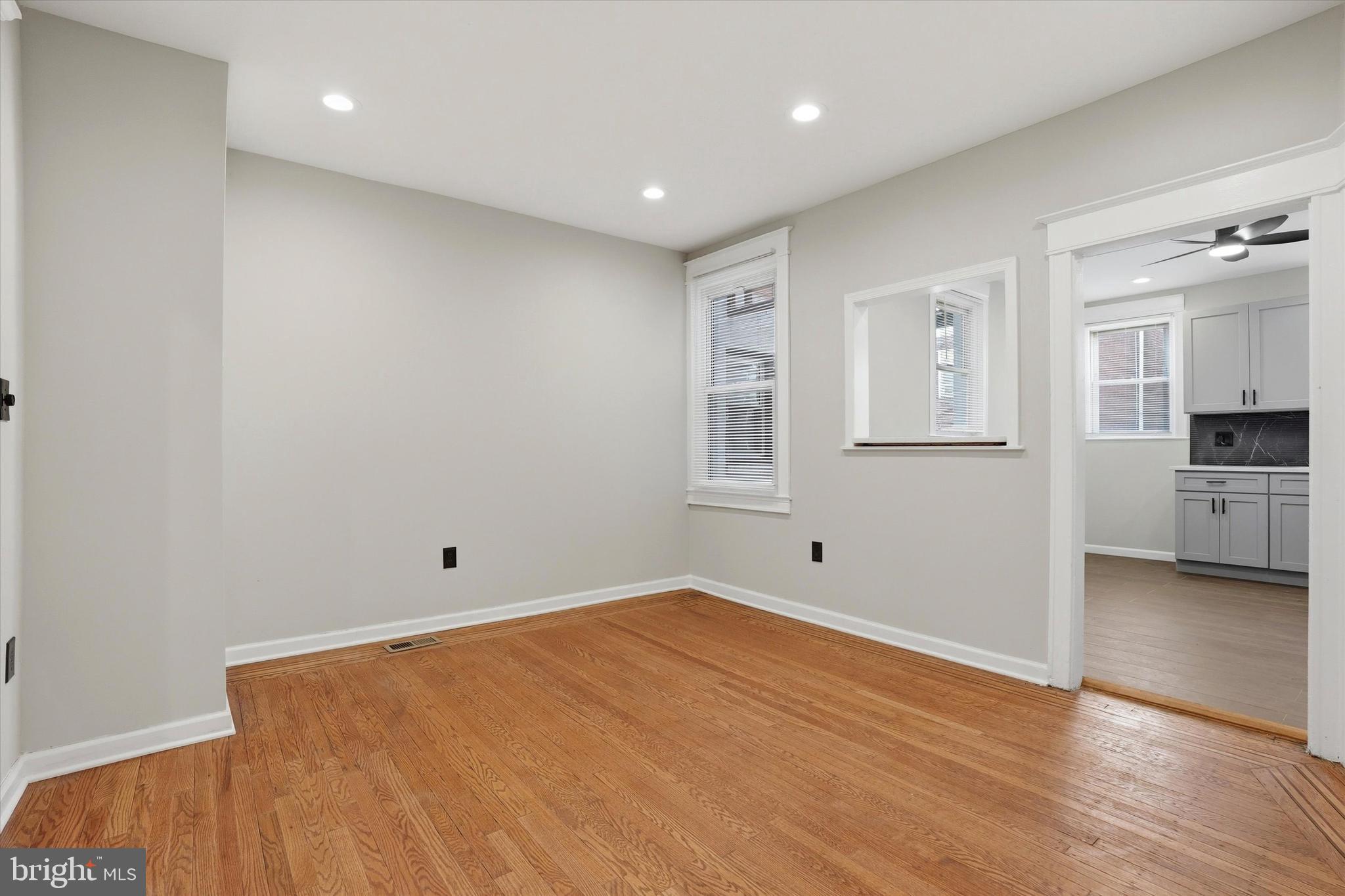 6258 Magnolia Street Philadelphia, PA 19144 - Photo 10 of 25 a view of empty room with wooden floor and window