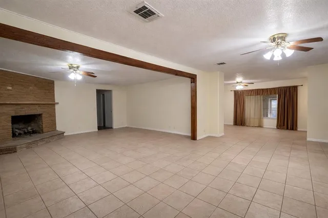 a view of an empty room with a fireplace