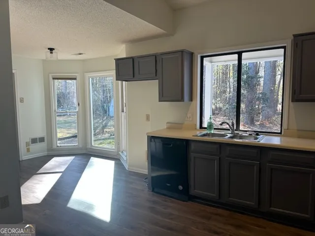 a kitchen with a sink and large window
