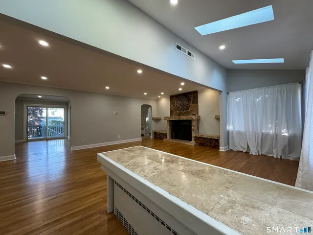 a view of kitchen and hall with wooden floor