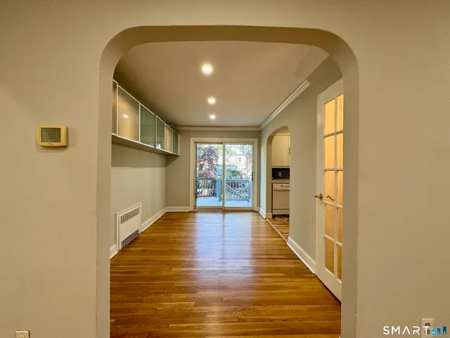 a view of an entryway with wooden floor