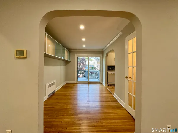 a view of an entryway with wooden floor