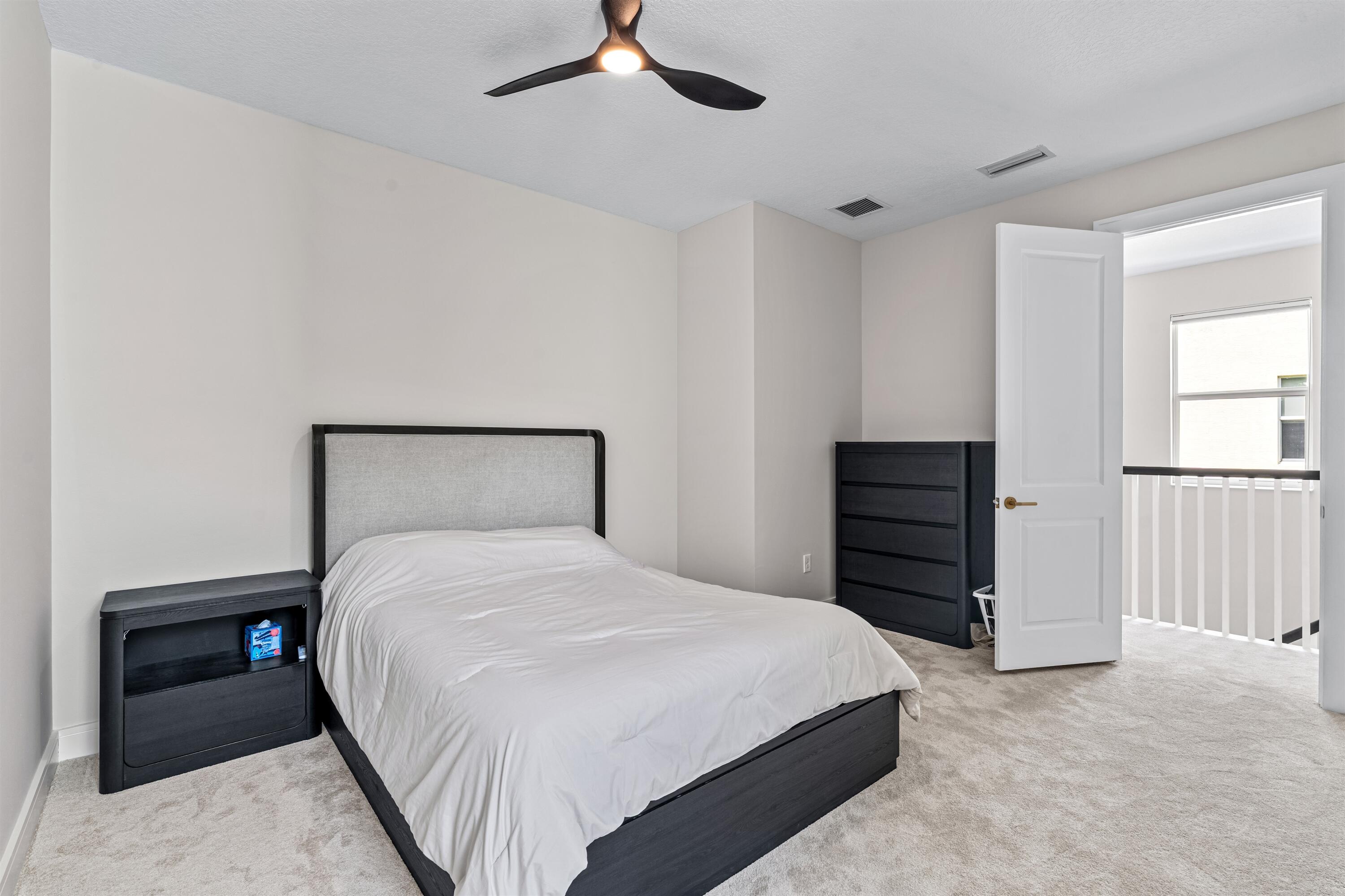 1570 Northwest 48th Place Boca Raton, FL 33431 - Photo 21 of 30 a bedroom with a bed and a dresser