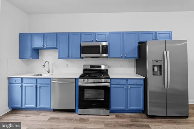a kitchen with a sink and a refrigerator