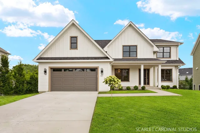 a front view of a house with a yard and garage