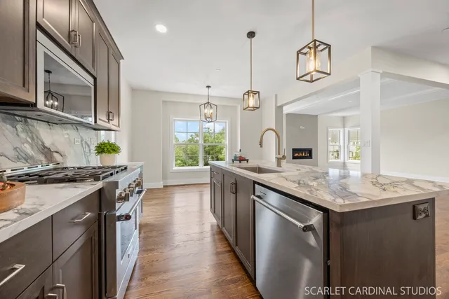 a kitchen with stainless steel appliances granite countertop a stove and a sink