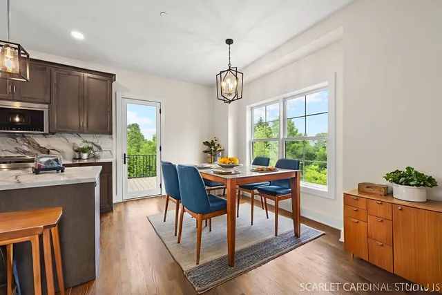 a view of a dining room with furniture window and wooden floor
