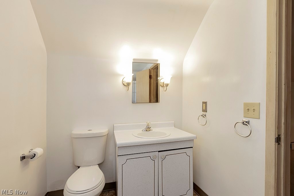 23655 Wimbledon Road Shaker Heights, OH 44122 - Photo 14 of 23 Bathroom featuring vaulted ceiling, vanity, and toilet