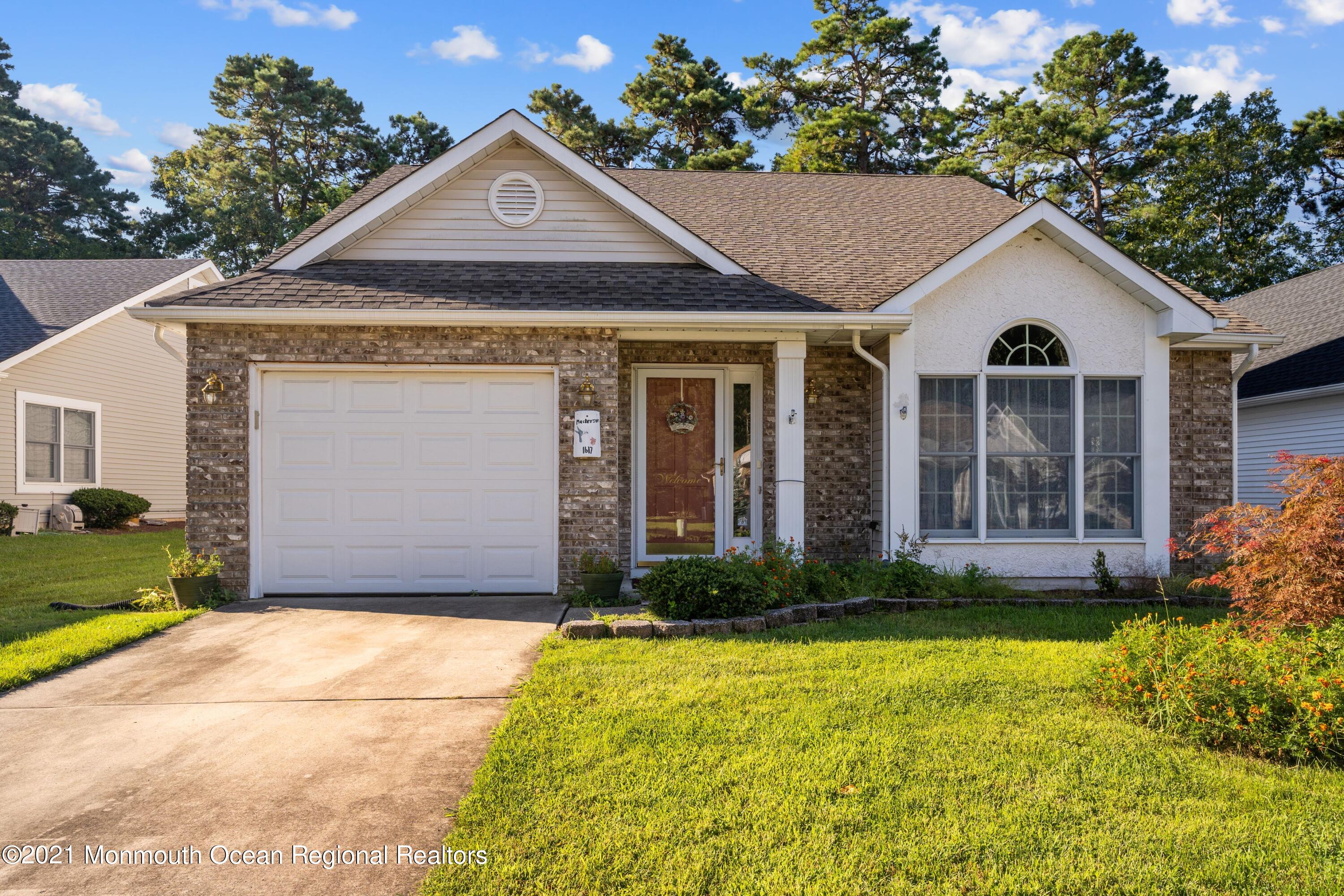 1617 Sweetbay Drive Toms River, NJ 08755 - Photo 1 of 18 a front view of a house with garden