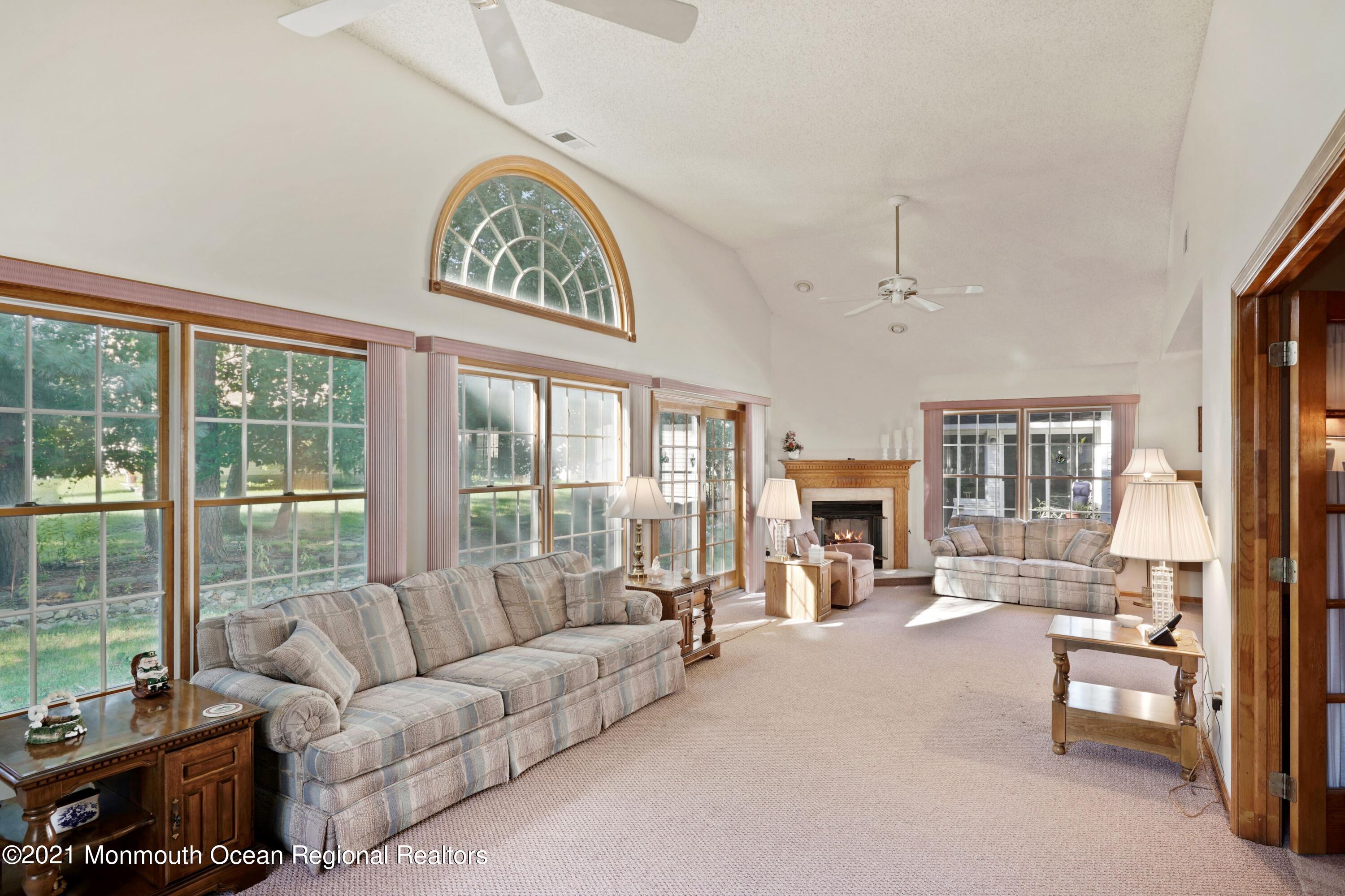 1617 Sweetbay Drive Toms River, NJ 08755 - Photo 12 of 18 a living room with furniture a fireplace and a large window with balcony view