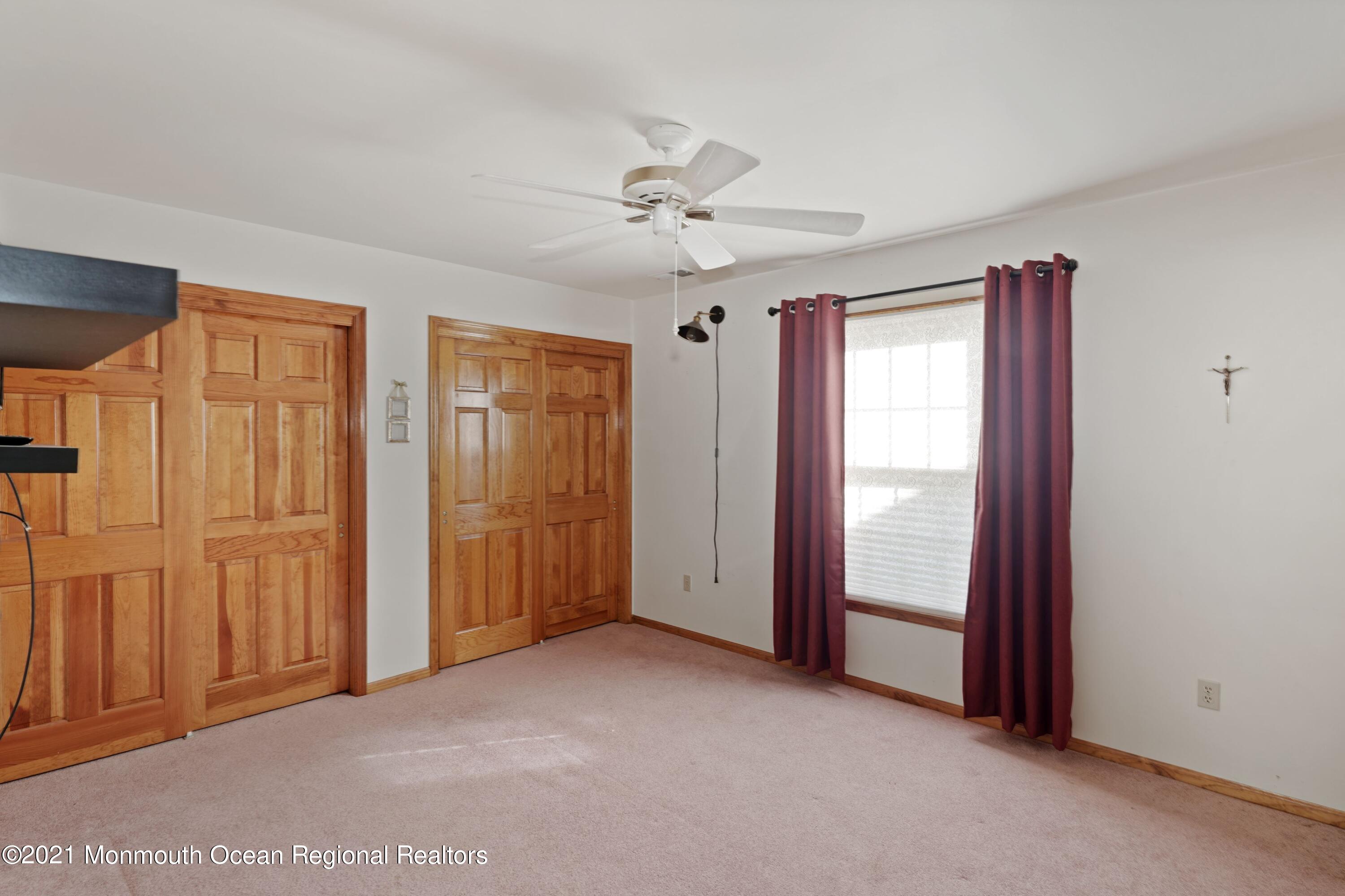 1617 Sweetbay Drive Toms River, NJ 08755 - Photo 15 of 18 an empty room with windows and fan