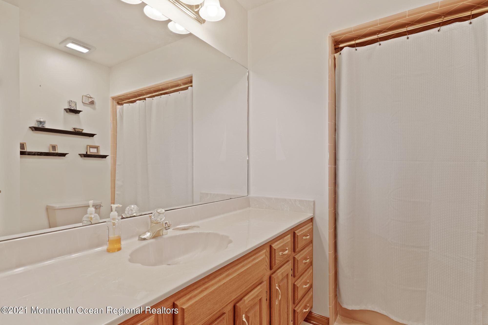 1617 Sweetbay Drive Toms River, NJ 08755 - Photo 6 of 18 a bathroom with a sink and a mirror