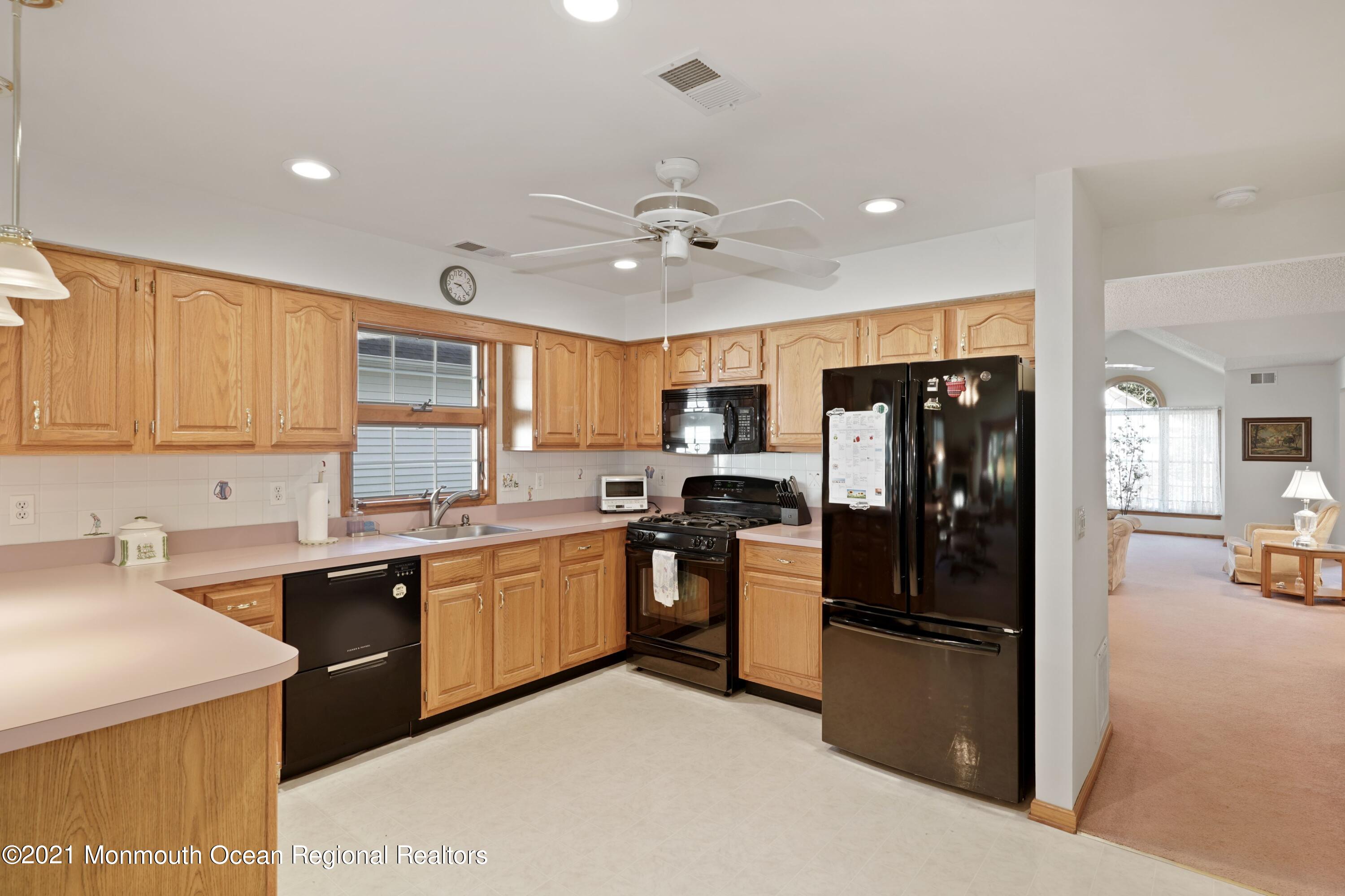1617 Sweetbay Drive Toms River, NJ 08755 - Photo 7 of 18 a kitchen with stainless steel appliances granite countertop a refrigerator a sink dishwasher a stove top oven a refrigerator with island and chairs