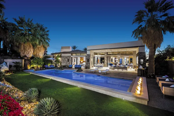 a view of a house with swimming pool and sitting area