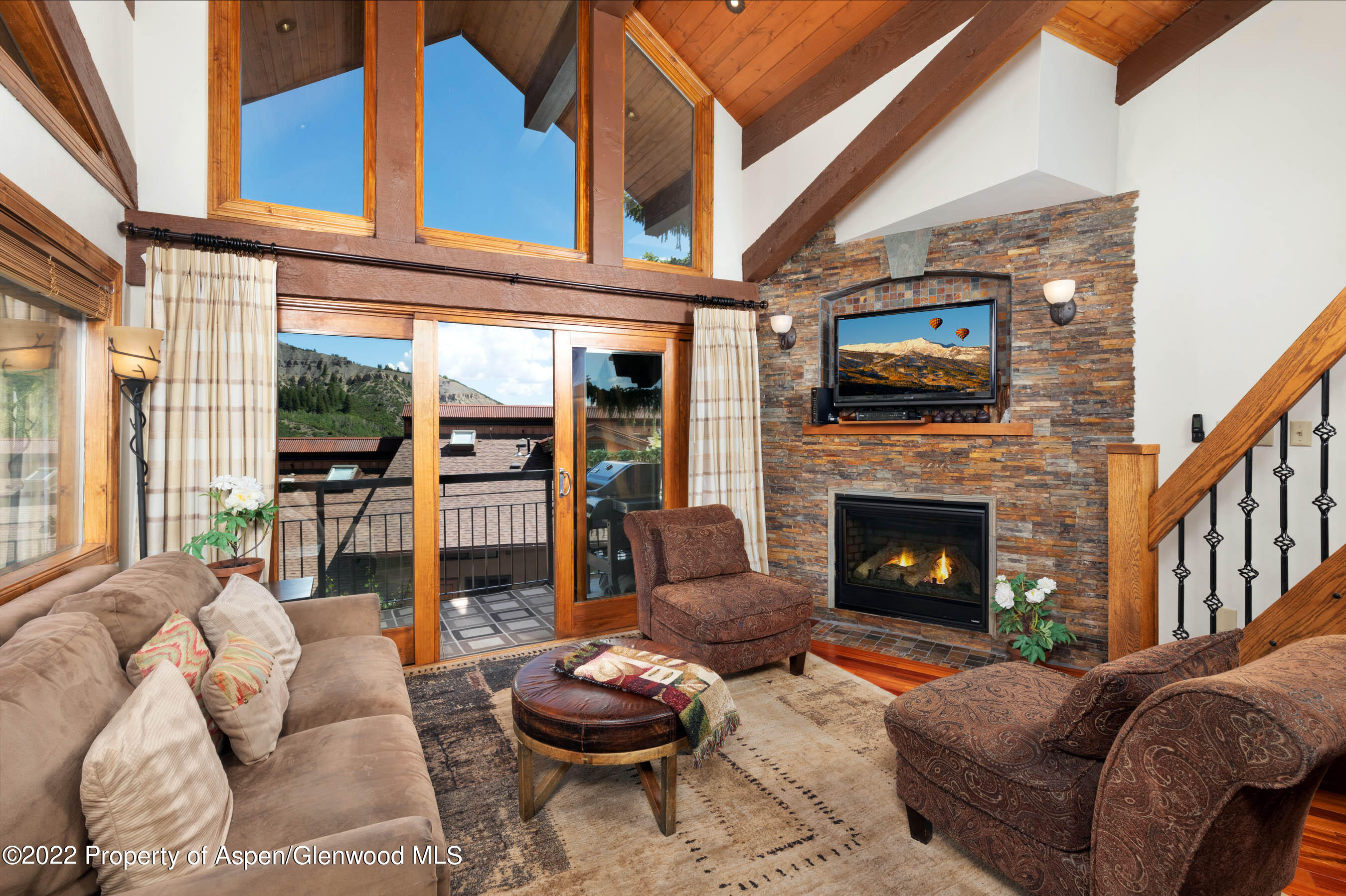 400 Wood Road, Unit 2310 Snowmass Village, CO 81615 - Photo 2 of 18 a living room with furniture a fireplace and a flat screen tv