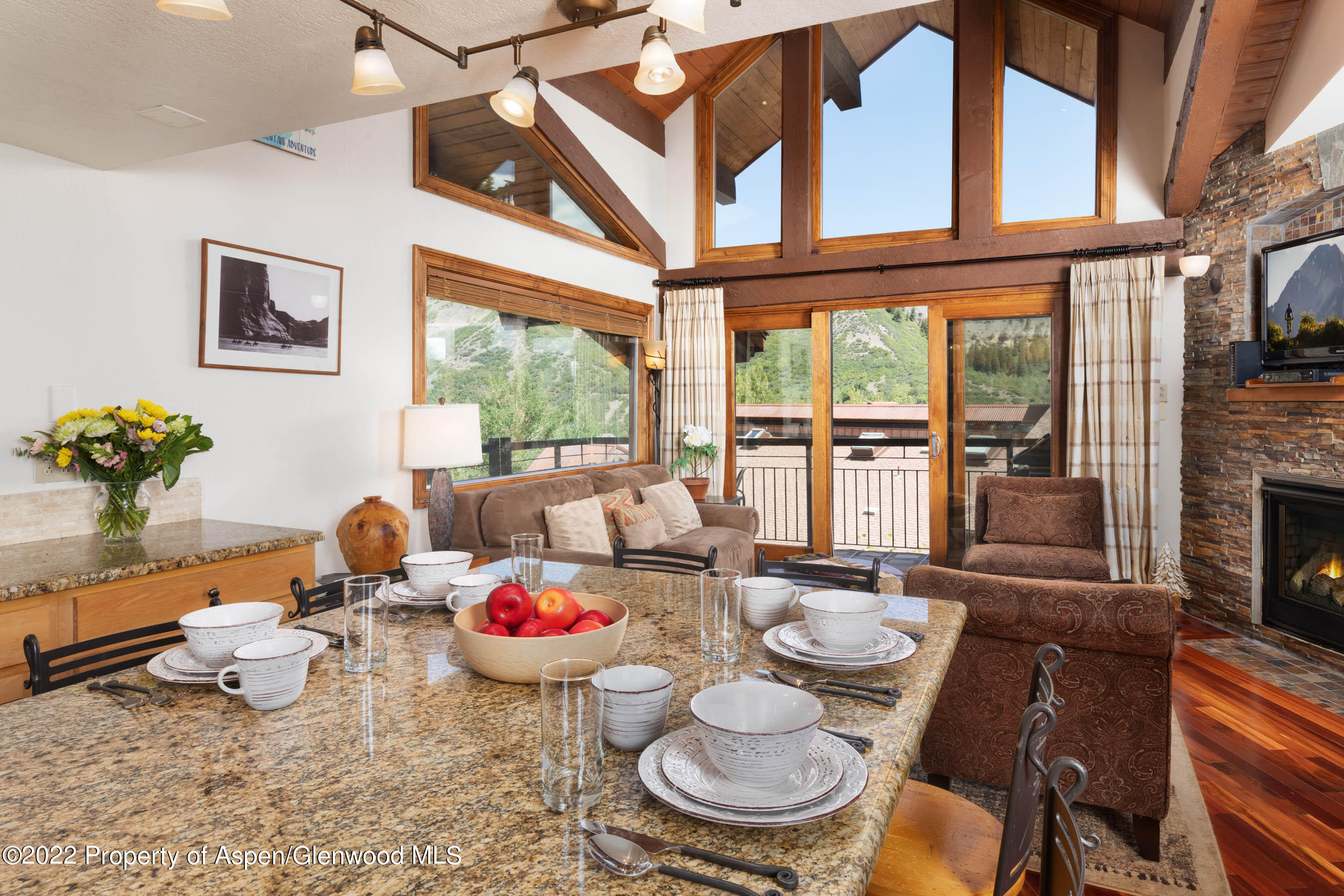 400 Wood Road, Unit 2310 Snowmass Village, CO 81615 - Photo 3 of 18 a dining room with furniture a fireplace and large windows