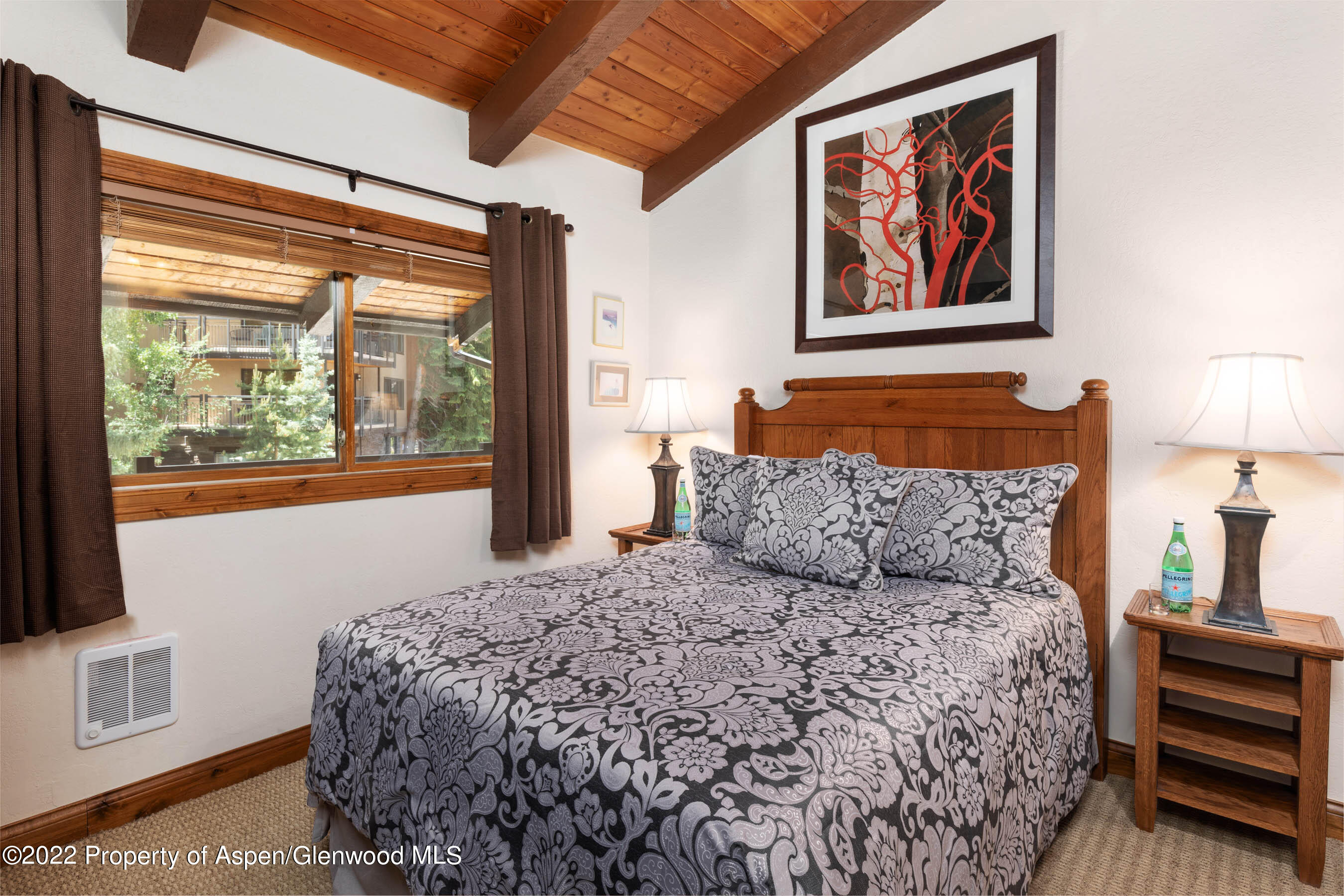 400 Wood Road, Unit 2310 Snowmass Village, CO 81615 - Photo 7 of 18 a bed sitting in a bedroom next to a window