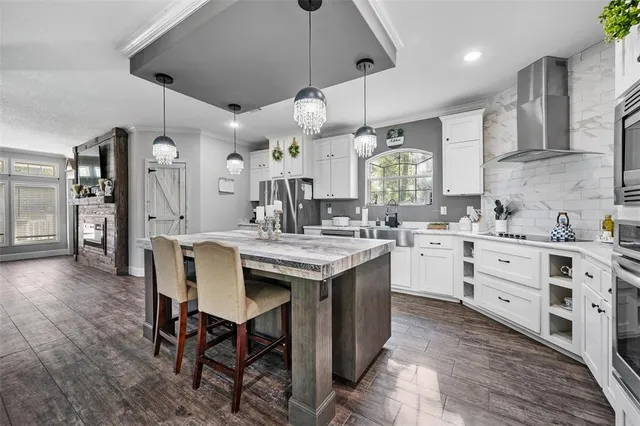 a kitchen with a table chairs appliances and cabinets