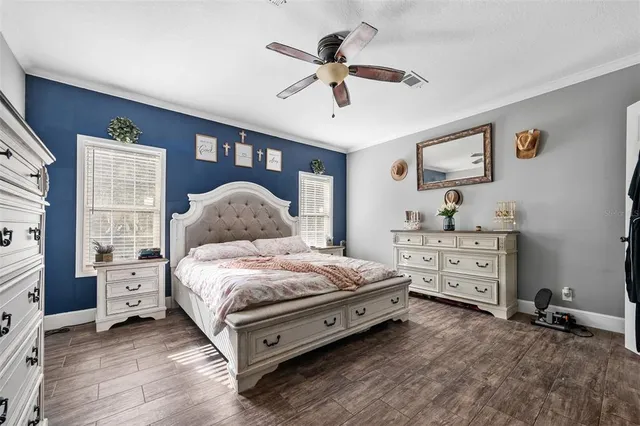 a spacious bedroom with a bed and a window