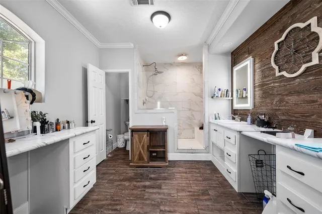 a large white kitchen with a sink and a stove top oven