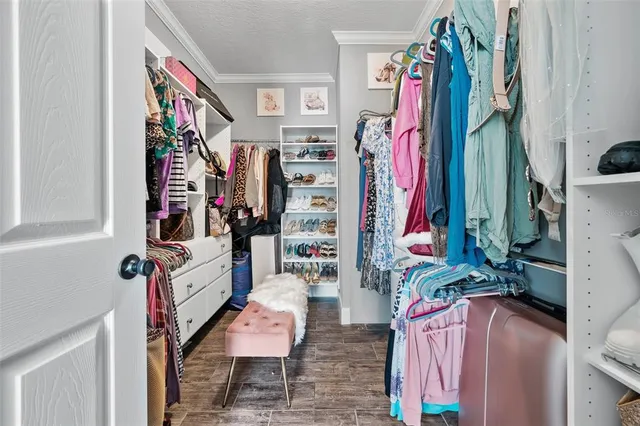 a view of walk in closet with clothes