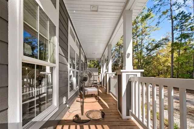 a view of balcony with wooden floor and fence
