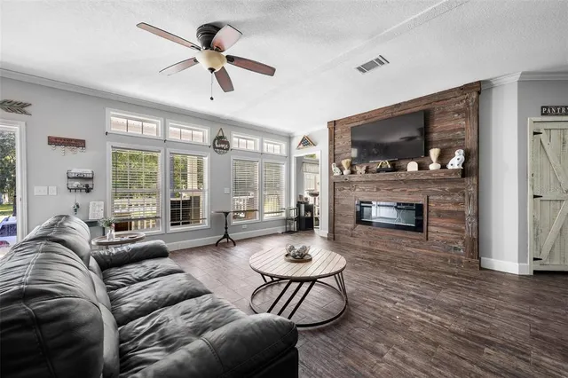 a living room with furniture a fireplace and a flat screen tv