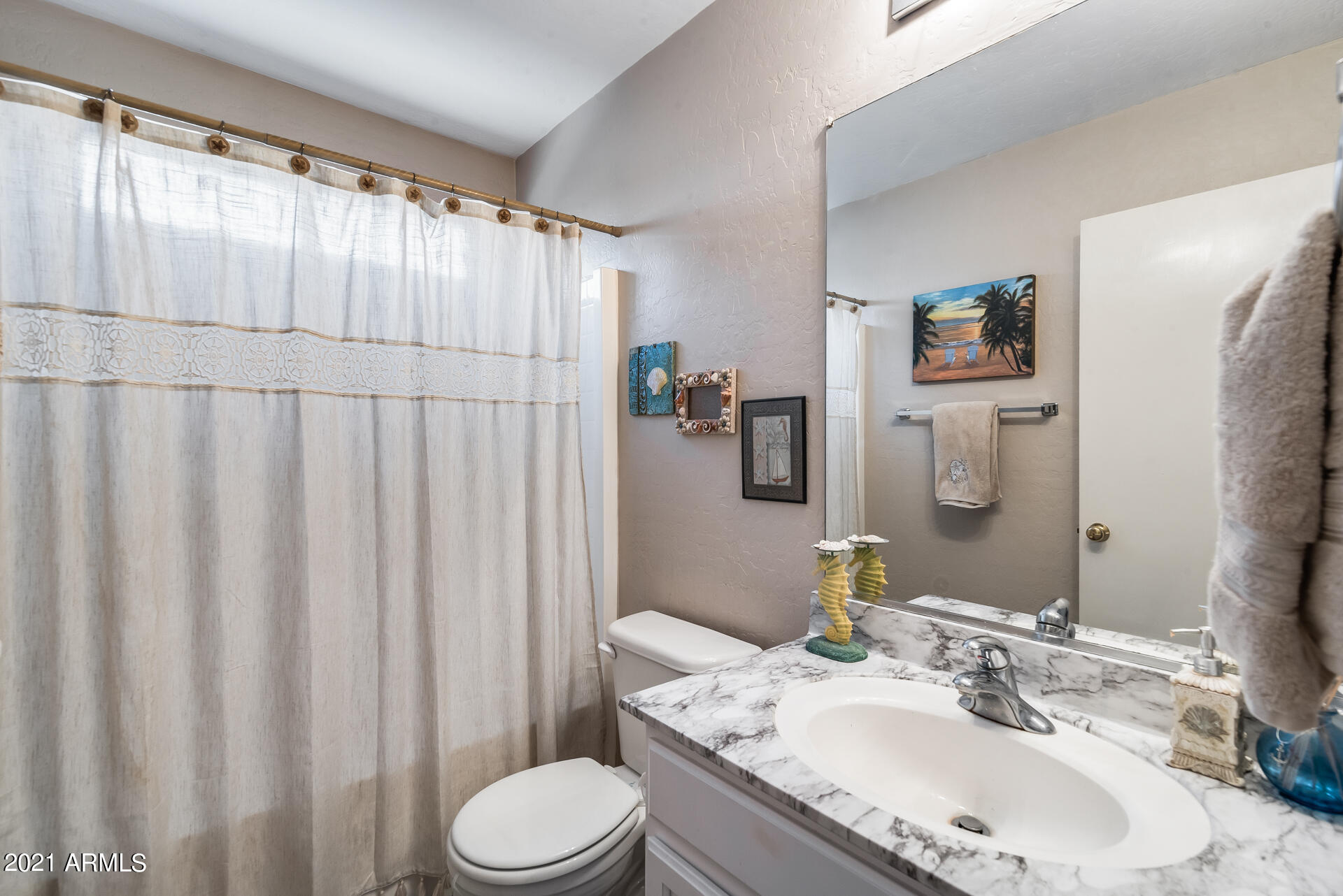 15037 West Calavar Road Surprise, AZ 85379 - Photo 13 of 28 a bathroom with a granite countertop sink and a mirror