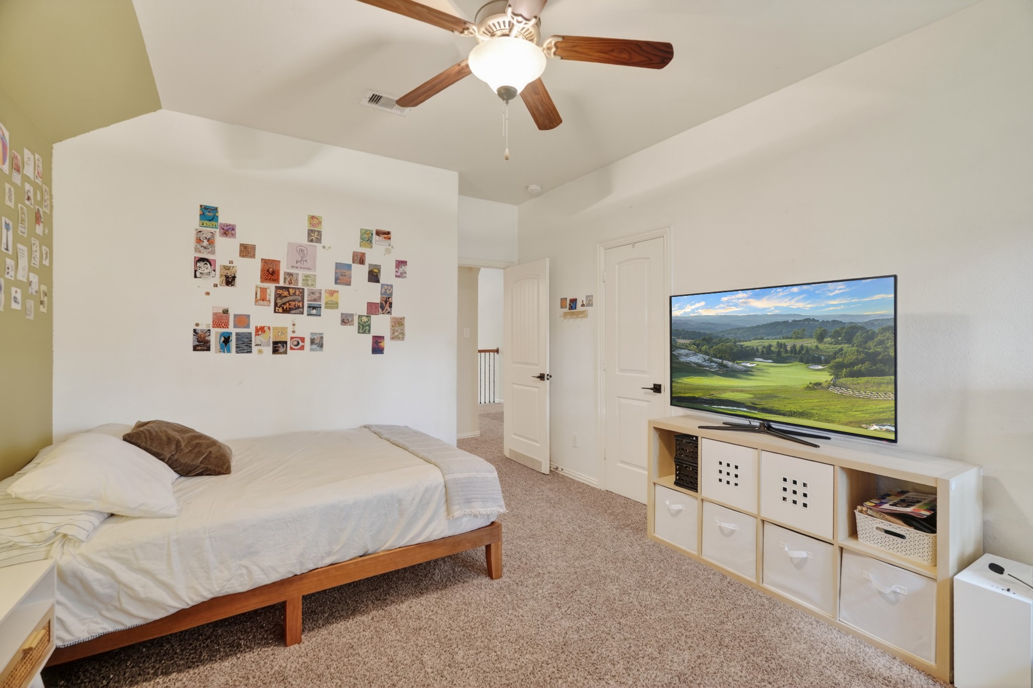 79 West Jagged Ridge Circle Spring, TX 77389 - Photo 32 of 50 This bright secondary bedroom features a cheerful accent wall, plush carpet, and a large window overlooking the backyard. With space for a bed, desk, and additional furniture, it's a versatile room ready to be styled for a child, teen, or guest.